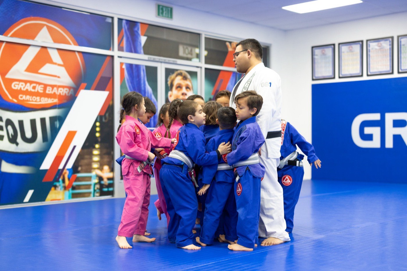 Kids crowd their instructor in a group hug